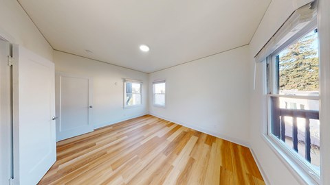 A room with wooden floors and white walls.
