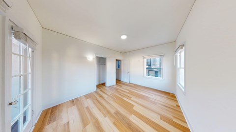 A room with wooden floors and white walls.