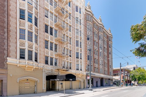 A large, ornate building with a red brick facade and white trim.