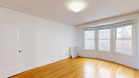 A room with wooden floors and white walls.