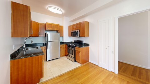 A kitchen with wooden cabinets and a white refrigerator.