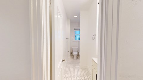 A white bathroom with a toilet and sink.