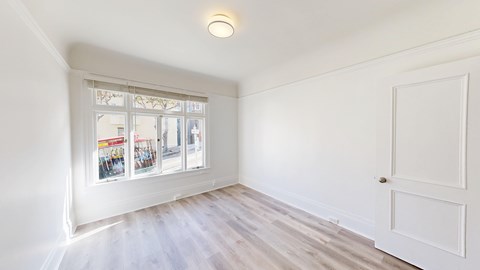 A white room with a window and a door.