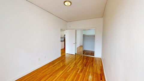 A room with wooden floors and white walls.
