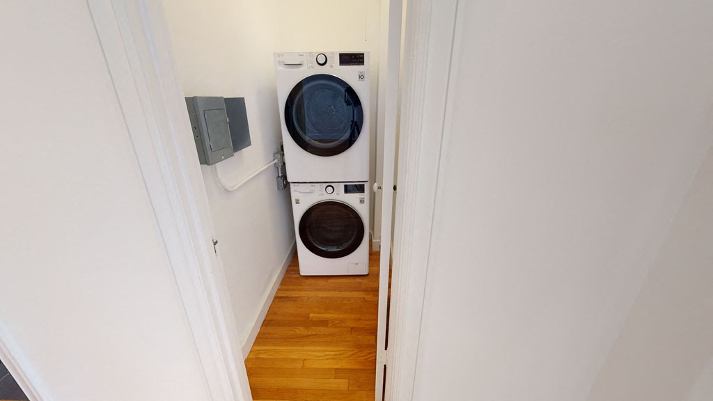 a washing machine and dryer in a small laundry room