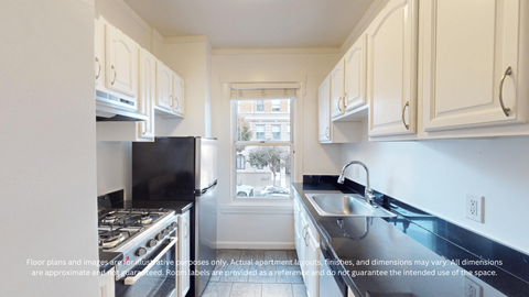 A kitchen with white cabinets and a black stove top oven.