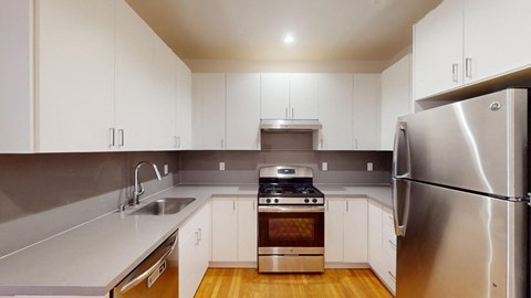 a kitchen with white cabinets and stainless steel appliances