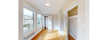 a living room with a large window and a wood floor