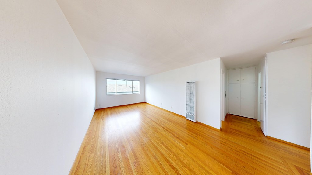 A room with wooden floors and white walls.