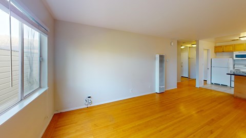 A room with wooden floors and white walls.
