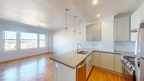 an empty kitchen with white cabinets and a large island