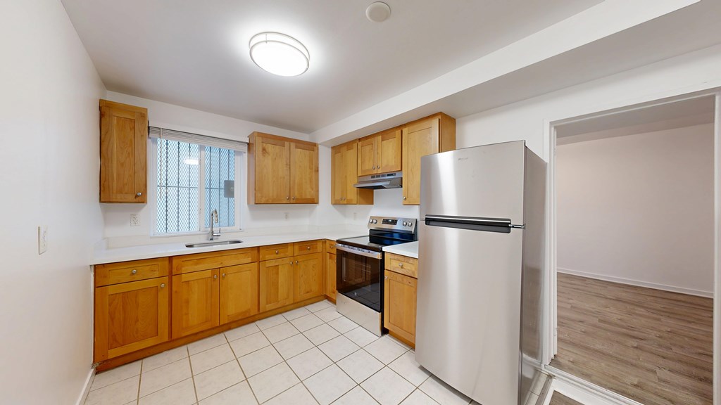 A kitchen with wooden cabinets and a white refrigerator.