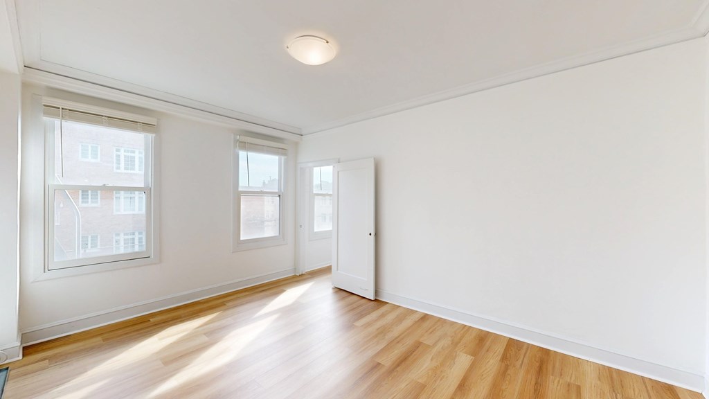 A room with wooden floors and white walls.