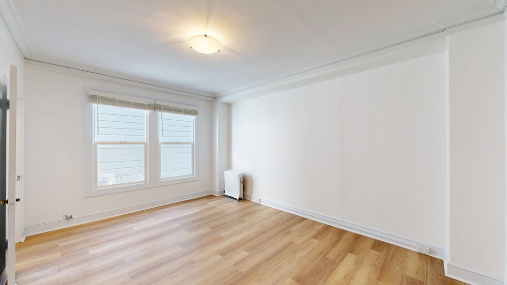A room with wooden floors and white walls.