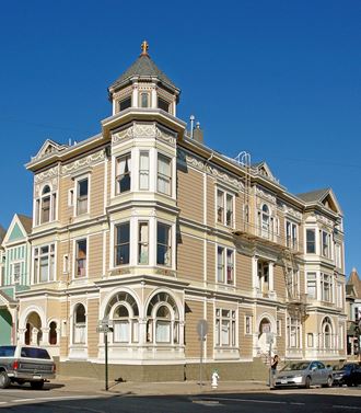 a large building on the corner of a street