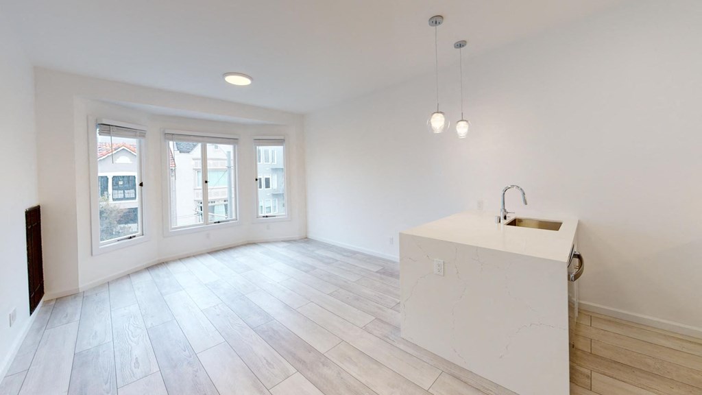 a white kitchen with a island in the middle of it