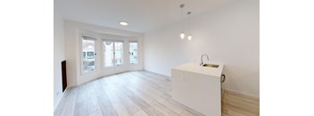 a white kitchen with a island in the middle of it