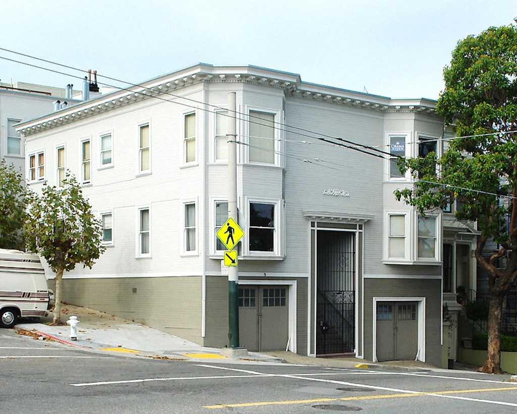 a white building on the corner of a street