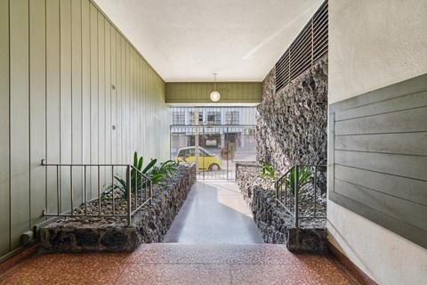 Apartment hallway with railings and plants