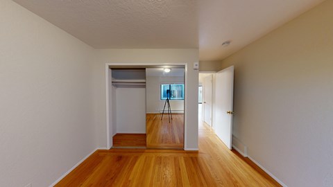 A room with wooden floors and white walls.