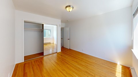 A room with wooden floors and white walls.