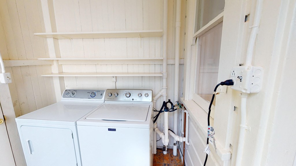 a white washer and dryer in a room with white walls