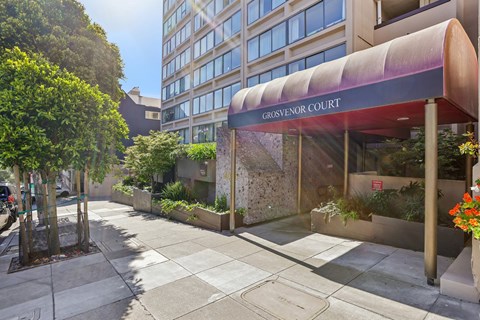 The entrance to Grosvenor Court is framed by a row of trees.