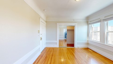 A room with wooden floors and white walls.