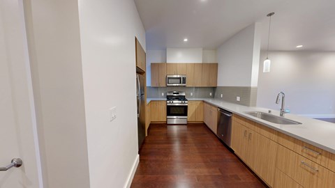 A kitchen with wooden floors and white walls.