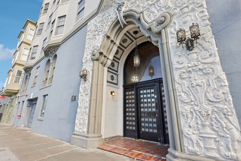 A building with a black door and a decorative archway.