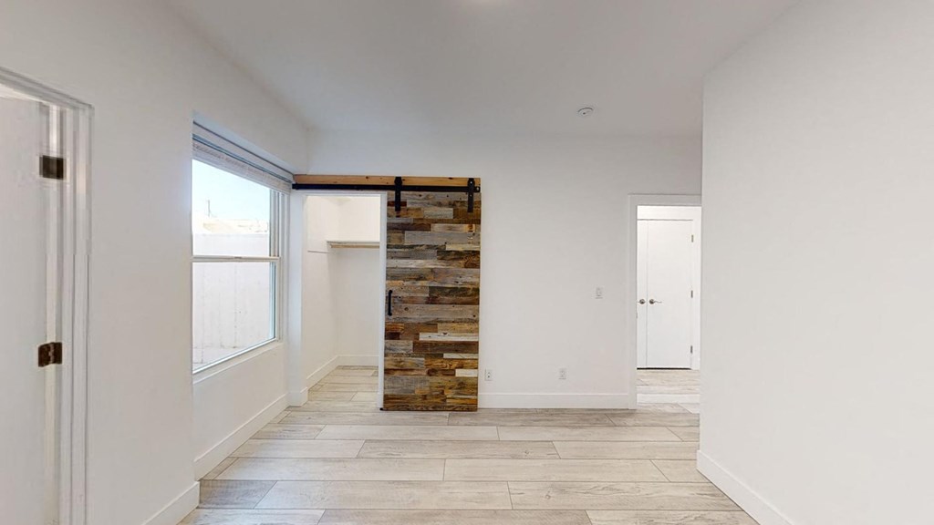 a hallway with a stone wall in the middle of a room