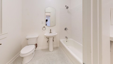 A white toilet and sink in a bathroom.
