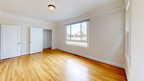 A room with wooden floors and a window.