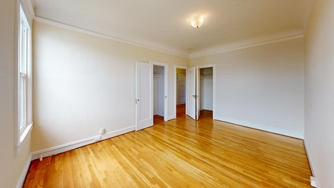 A room with wooden floors and white walls.