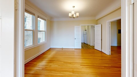 A room with wooden floors and white walls.