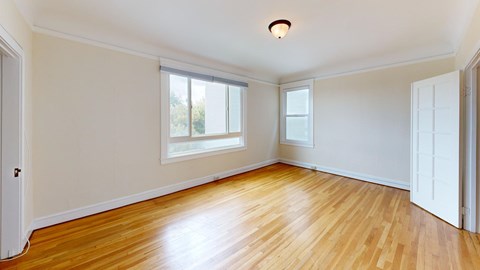 A room with wooden floors and white walls.