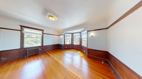 A room with wooden floors and white walls.