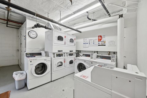Laundry room with washing machines neatly arranged on a wooden floor