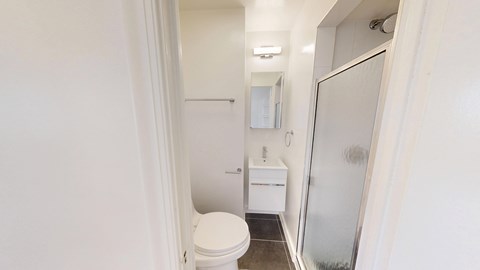 A white toilet is in a small bathroom.