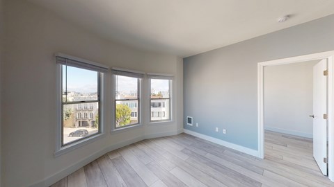 A room with a view of the city through the windows.