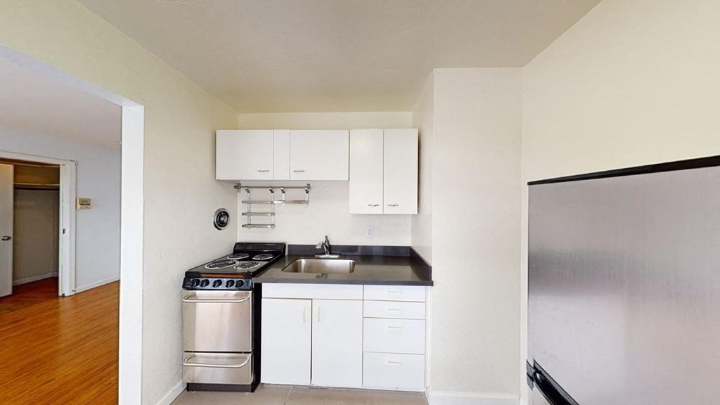 a kitchen with stainless steel appliances and white cabinets
