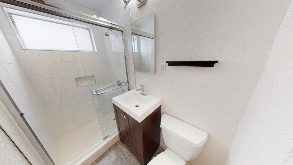 a bathroom with a sink toilet and a shower