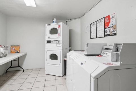 Laundry room with washing machines neatly arranged on a wooden floor