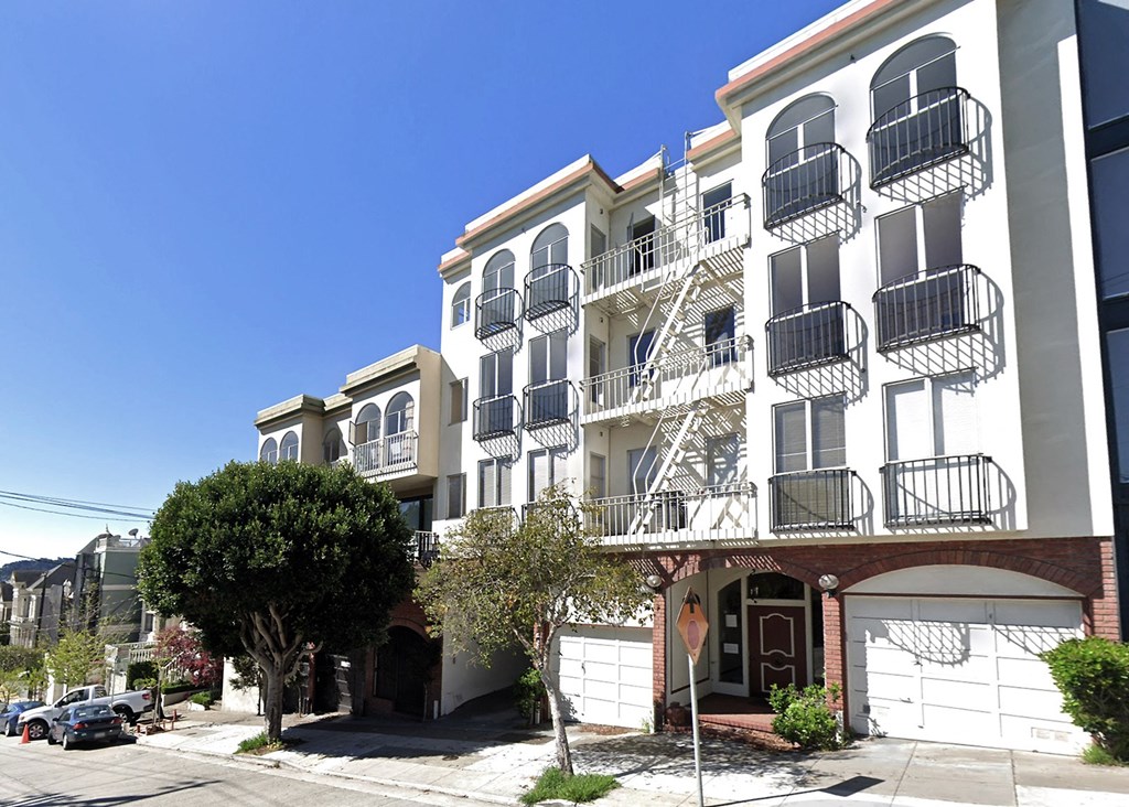 an apartment building with a staircase on the side of it