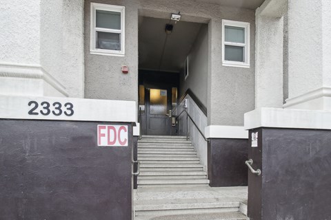 The stairs leading to the door of a building with the number 2333 and the letters FDC on the wall.