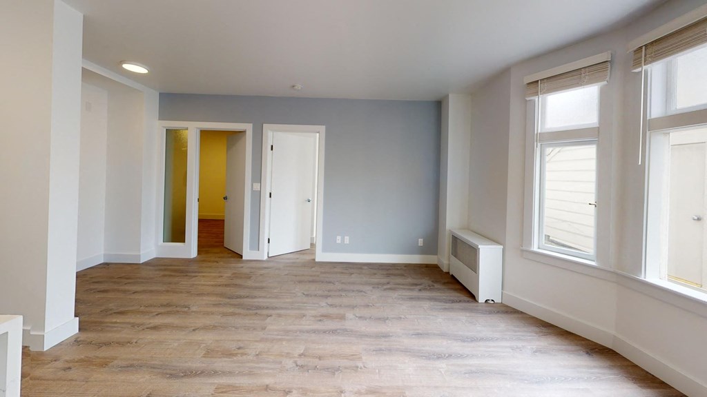 the living room and dining room of a new home with wood floors and blue walls