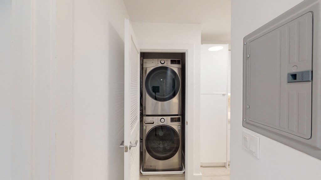 a white washer and dryer in a white laundry room