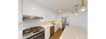 a kitchen with white cabinets and stainless steel appliances