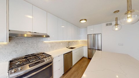 a kitchen with white cabinets and stainless steel appliances