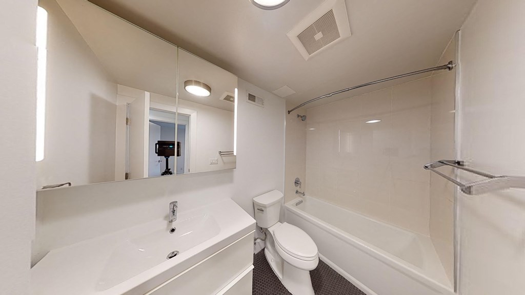 a bathroom with a sink toilet and a tub